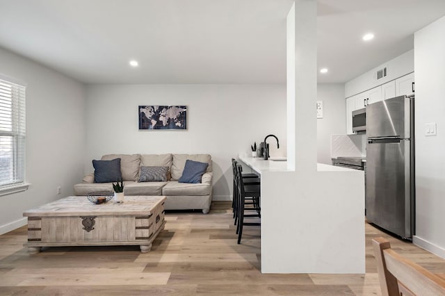 1203 Hollow Creek Dr Unit 101, Austin, TX 78704 - living room featuring recessed lighting and light wood finished floors