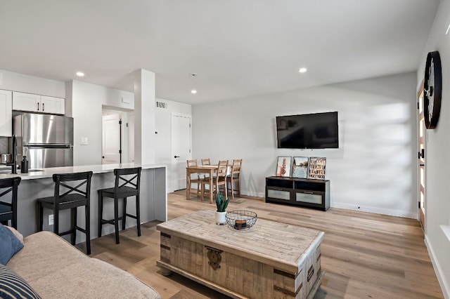 1203 Hollow Creek Dr Unit 101, Austin, TX 78704 - living area featuring light wood-style flooring and recessed lighting