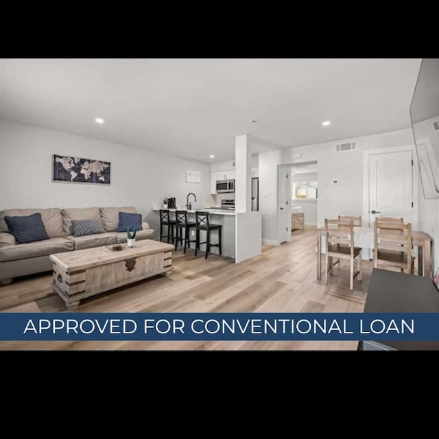 1203 Hollow Creek Dr Unit 101, Austin, TX 78704 - living area with light wood-style floors and recessed lighting