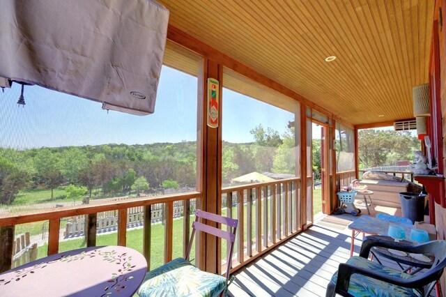 wooden deck with a wooded view