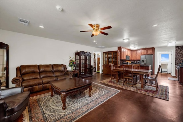 living room with visible vents, ceiling fan, finished concrete flooring, and recessed lighting