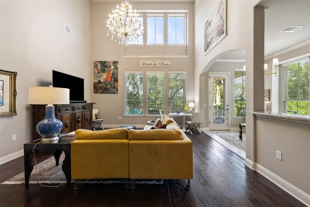 living area featuring baseboards, a chandelier, and visible vents