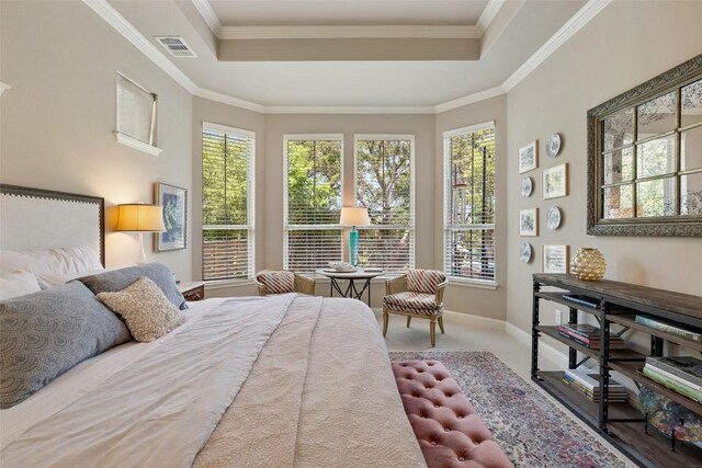 bedroom featuring crown molding, baseboards, visible vents, and a tray ceiling