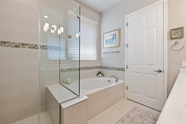 bathroom with a garden tub, vanity, tile patterned floors, and a stall shower