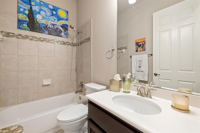 full bath featuring toilet, vanity, and shower / tub combination