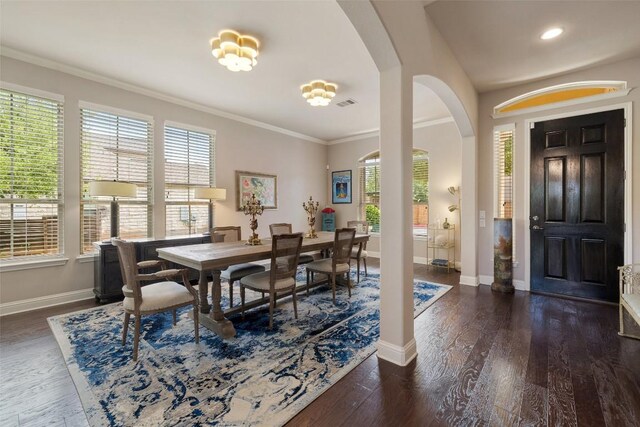 dining space featuring arched walkways, visible vents, baseboards, crown molding, and dark wood-type flooring