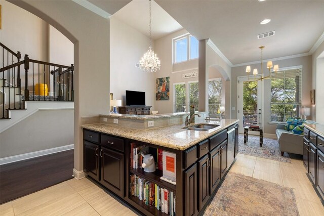 kitchen featuring a chandelier, visible vents, open floor plan, and a sink