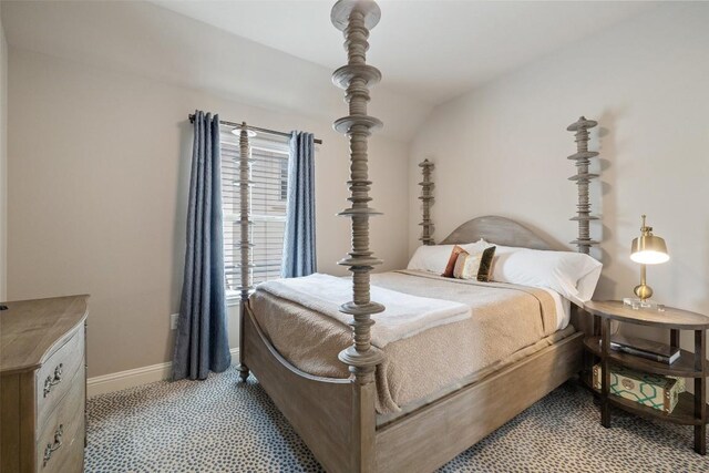 bedroom with baseboards and light colored carpet