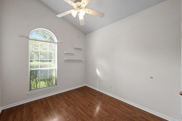 empty room featuring vaulted ceiling, ceiling fan, dark wood finished floors, and baseboards