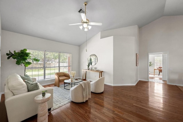 living room featuring high vaulted ceiling, wood finished floors, and plenty of natural light