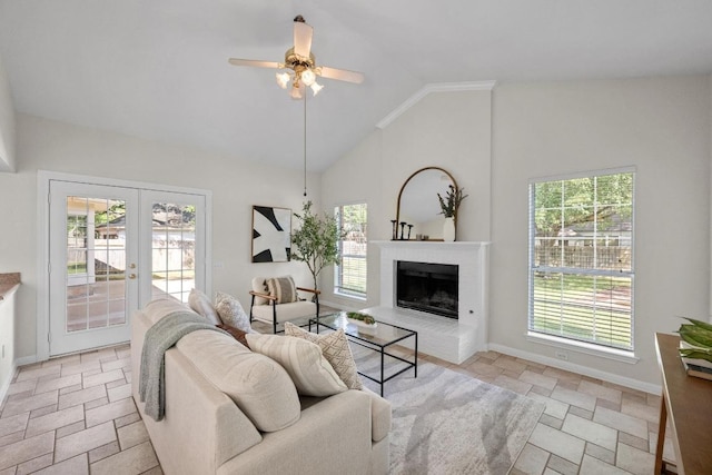 living area with french doors, baseboards, stone tile flooring, and plenty of natural light