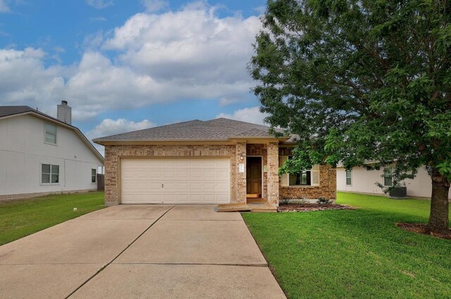408 Wiley St, Hutto, TX 78634 - view of front facade with concrete driveway, brick siding, a garage, and a front lawn