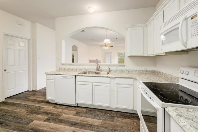 kitchen with dark wood-style floors, a sink, white cabinetry, a ceiling fan, and white appliances