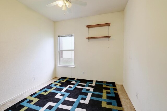 spare room with a ceiling fan and carpet flooring