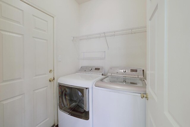 washroom featuring washing machine and dryer and laundry area