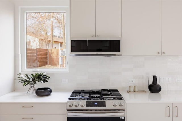 3209 Dolphin Dr Unit 2, Austin, TX 78704 - kitchen with stainless steel appliances, light countertops, backsplash, and plenty of natural light