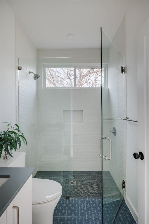 3209 Dolphin Dr Unit 2, Austin, TX 78704 - bathroom with a stall shower, vanity, and tile patterned floors