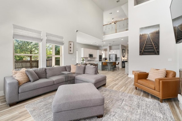 20401 Great Egret Ln, Pflugerville, TX 78660 - living room with light wood-style flooring and a high ceiling