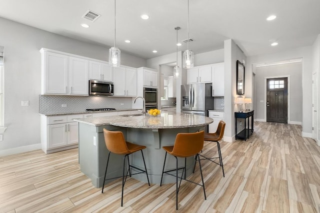20401 Great Egret Ln, Pflugerville, TX 78660 - kitchen featuring appliances with stainless steel finishes, tasteful backsplash, white cabinetry, and recessed lighting