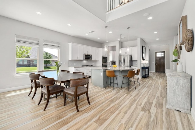 20401 Great Egret Ln, Pflugerville, TX 78660 - dining room with light wood-style flooring and recessed lighting