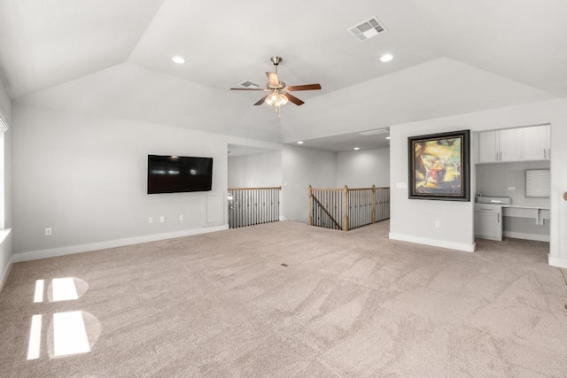 20401 Great Egret Ln, Pflugerville, TX 78660 - unfurnished living room with vaulted ceiling, light carpet, ceiling fan, and recessed lighting
