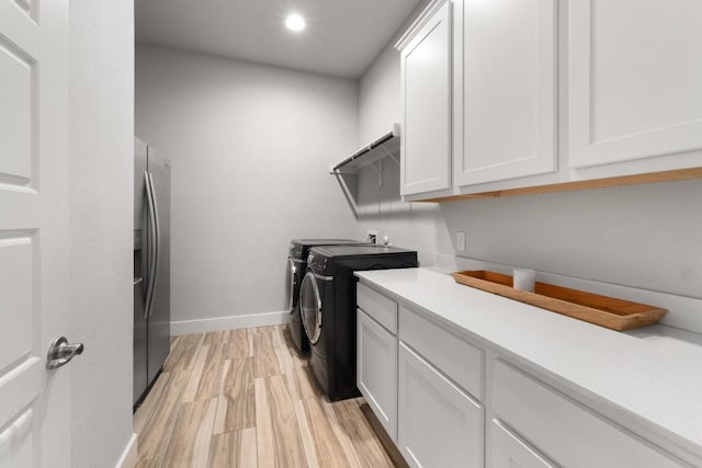 20401 Great Egret Ln, Pflugerville, TX 78660 - washroom with washer and clothes dryer, cabinet space, light wood finished floors, and recessed lighting