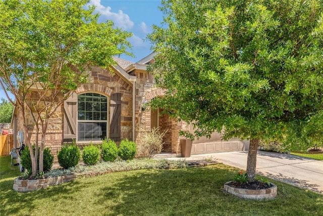 800 Allende Bnd, Austin, TX 78748 - view of front facade featuring stone siding, driveway, a front lawn, and a garage