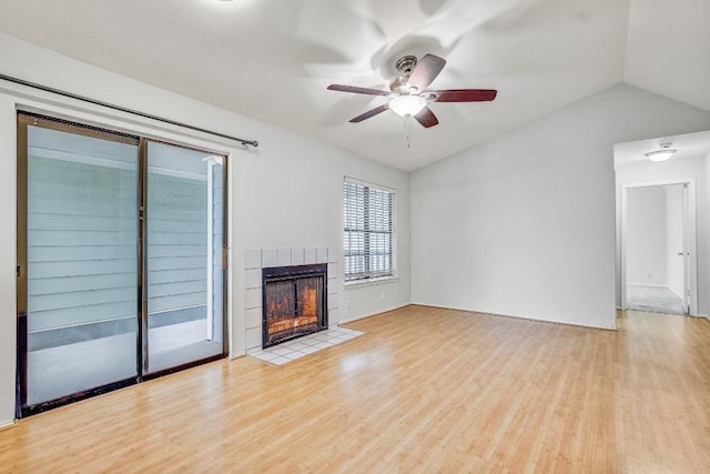 2215 Post Rd Unit 2022, Austin, TX 78704 - unfurnished living room with wood finished floors, vaulted ceiling, a fireplace, and a ceiling fan