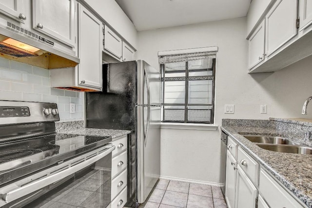 2215 Post Rd Unit 2022, Austin, TX 78704 - kitchen with appliances with stainless steel finishes, under cabinet range hood, tasteful backsplash, light tile patterned flooring, and light stone counters