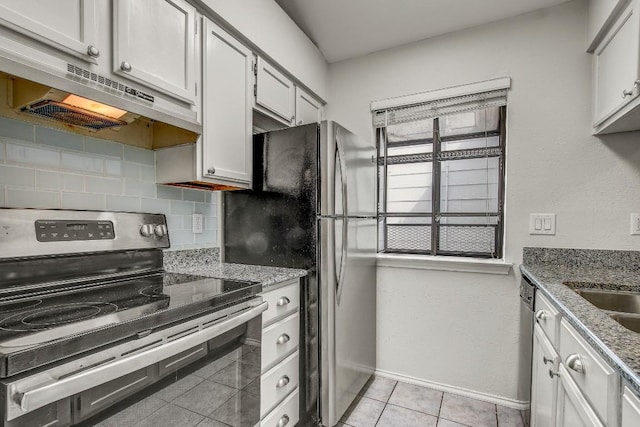 2215 Post Rd Unit 2022, Austin, TX 78704 - kitchen featuring stainless steel appliances, tasteful backsplash, under cabinet range hood, light stone countertops, and light tile patterned flooring
