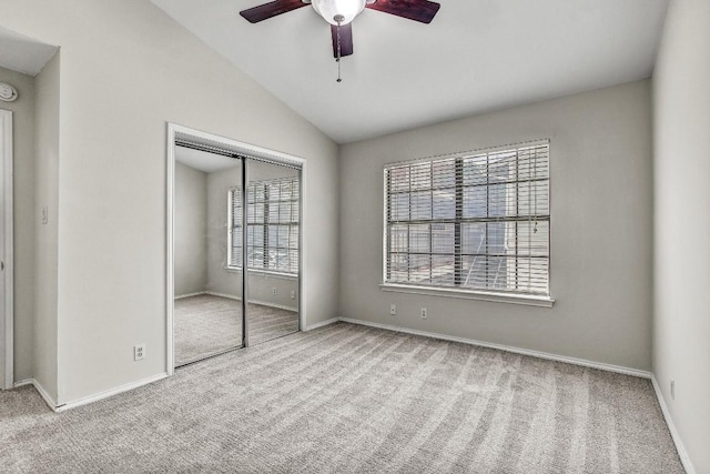 2215 Post Rd Unit 2022, Austin, TX 78704 - unfurnished bedroom with carpet floors, vaulted ceiling, baseboards, a closet, and ceiling fan