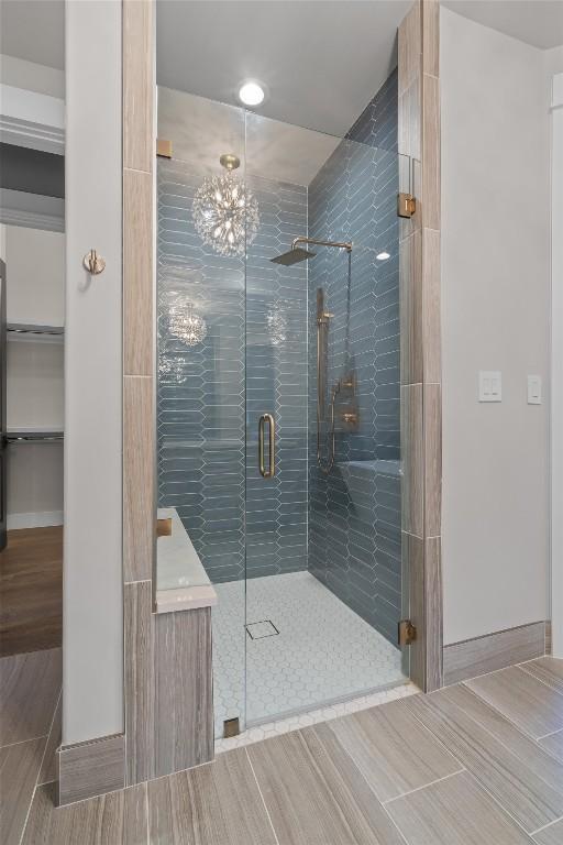 8 Cove Creek Ln, Austin, TX 78738 - full bathroom with a stall shower, a chandelier, and vanity