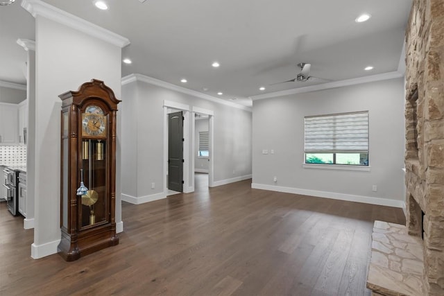 8 Cove Creek Ln, Austin, TX 78738 - unfurnished living room featuring ornamental molding, ceiling fan, dark wood finished floors, recessed lighting, and a stone fireplace