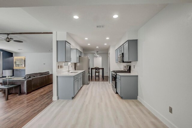 12319 Wycliff Ln, Austin, TX 78727 - kitchen with stainless steel appliances, gray cabinets, and recessed lighting