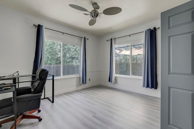 12319 Wycliff Ln, Austin, TX 78727 - home office with wood finished floors, a ceiling fan, and plenty of natural light