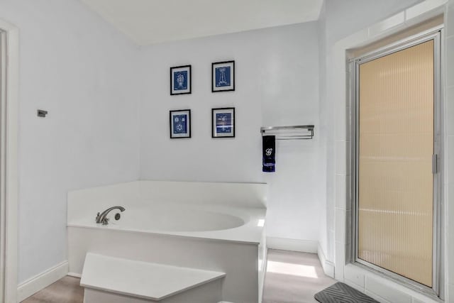 12319 Wycliff Ln, Austin, TX 78727 - full bath with a bath, baseboards, and wood finished floors