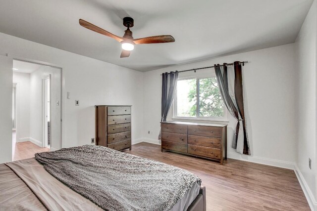 12319 Wycliff Ln, Austin, TX 78727 - bedroom featuring wood finished floors, baseboards, and a ceiling fan