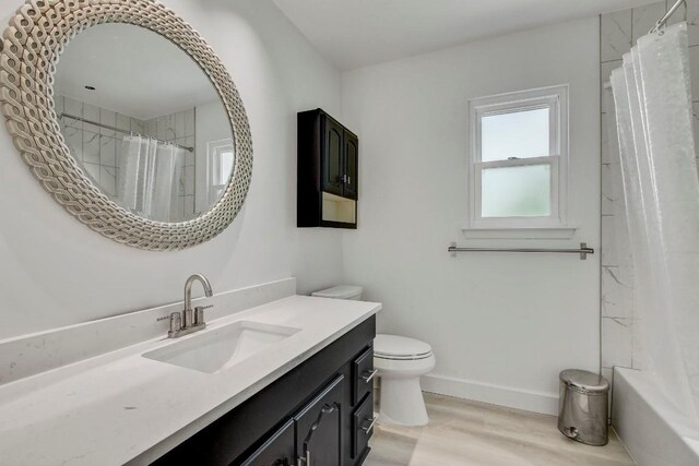 12319 Wycliff Ln, Austin, TX 78727 - bathroom featuring vanity, toilet, wood finished floors, and baseboards