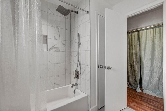 12319 Wycliff Ln, Austin, TX 78727 - bathroom featuring shower / bath combination with curtain and wood finished floors