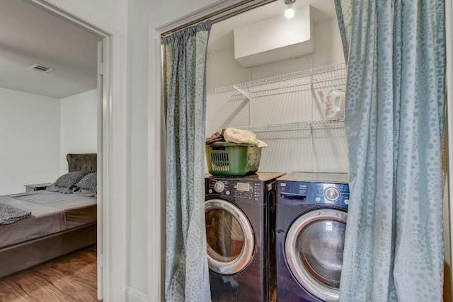 12319 Wycliff Ln, Austin, TX 78727 - laundry room featuring washer and dryer and wood finished floors