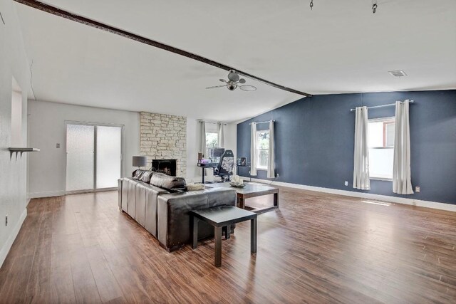 12319 Wycliff Ln, Austin, TX 78727 - living area with wood finished floors, a stone fireplace, lofted ceiling, baseboards, and ceiling fan