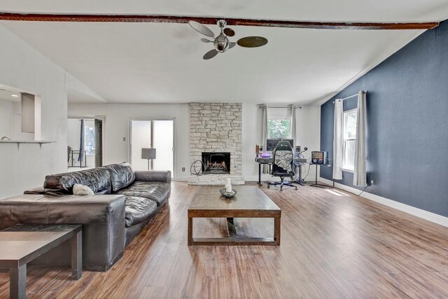 12319 Wycliff Ln, Austin, TX 78727 - living room featuring ceiling fan, wood finished floors, a fireplace, and baseboards