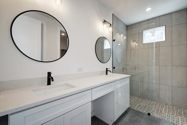 407 Delmar Ave Unit A, Austin, TX 78752 - bathroom featuring double vanity, tiled shower, tile patterned floors, and recessed lighting