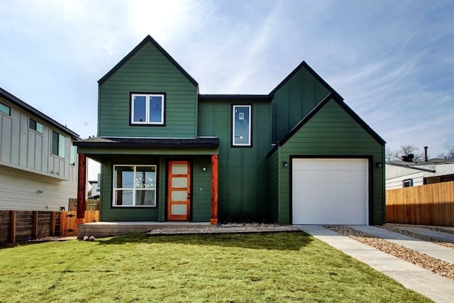 view of front of property with fence, a front yard, board and batten siding, and a garage