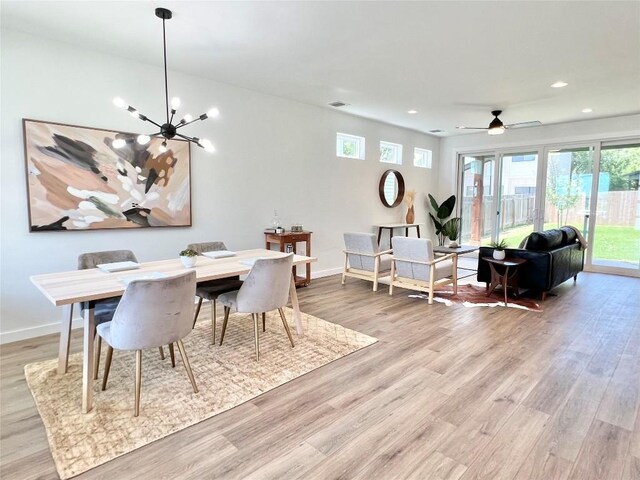 dining room with baseboards, light wood-style floors, visible vents, and recessed lighting