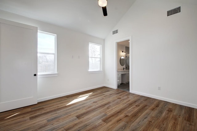 407 Delmar Ave Unit A, Austin, TX 78752 - unfurnished bedroom featuring wood finished floors, ensuite bath, ceiling fan, and high vaulted ceiling