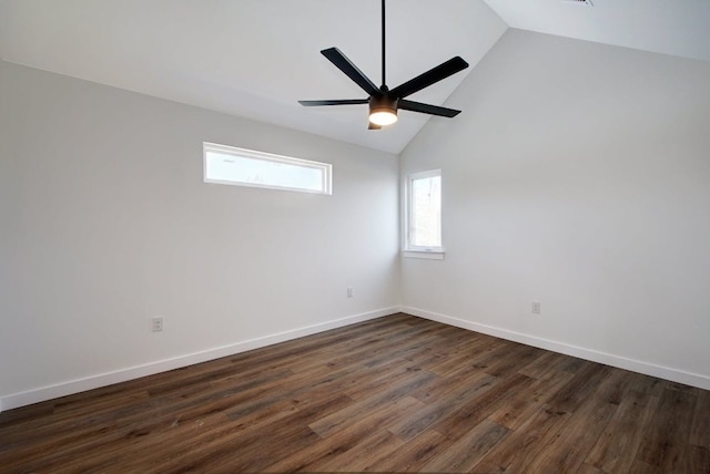 unfurnished room featuring dark wood-type flooring, vaulted ceiling, a ceiling fan, and baseboards