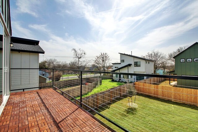 view of yard with a fenced backyard and a balcony