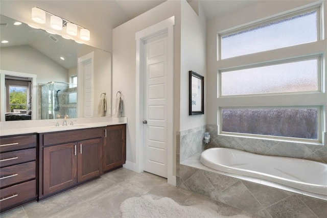 2500 Yuma Trl, Leander, TX 78641 - bathroom featuring vanity, a stall shower, a bath, healthy amount of natural light, and vaulted ceiling