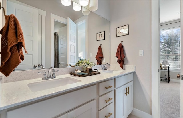 2500 Yuma Trl, Leander, TX 78641 - bathroom featuring double vanity and baseboards